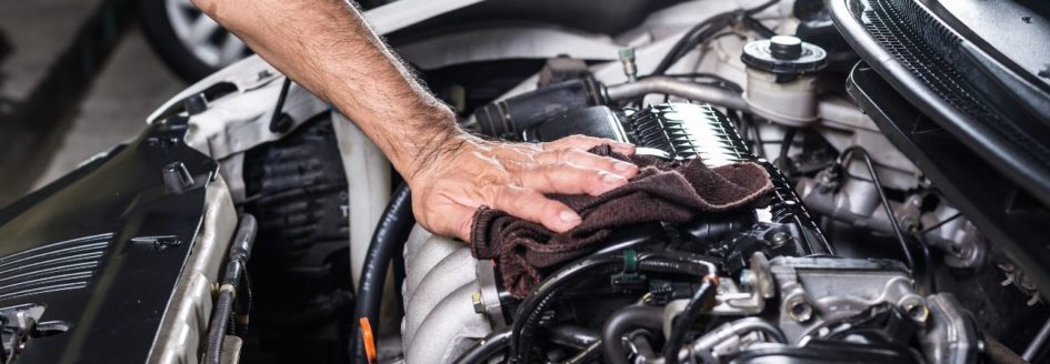 a car mechanic under the hood of a vehicle