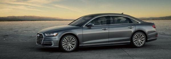 Silver 2019 Audi A8 parked in a sunny desert valley.